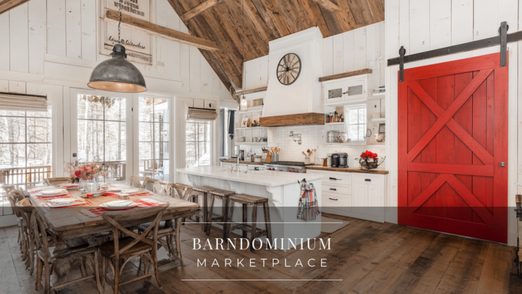 A bright barndominium interior with white shiplap walls, a bold red barn door, and a spacious dining area beneath vaulted ceilings.
